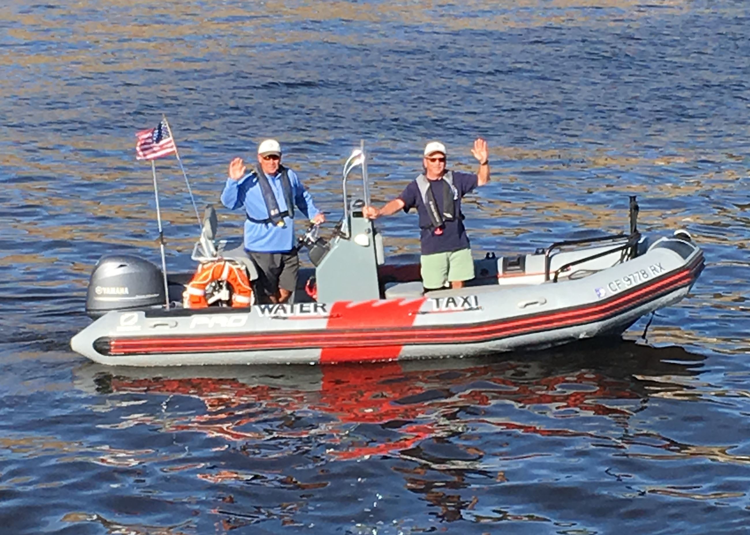 Water taxi hosts and patrons on water taxi boat